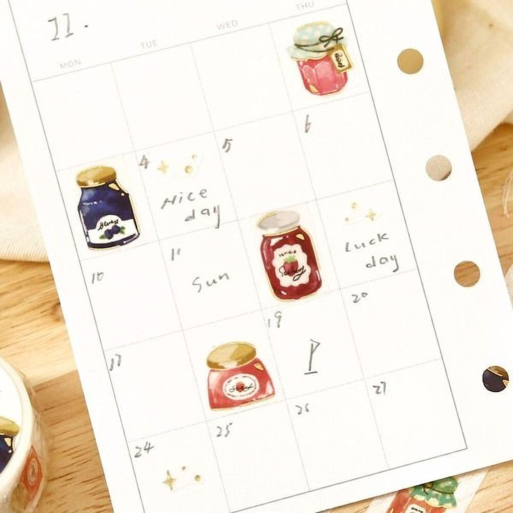 a calendar with various stickers representing different days of the week and jars of jam.
