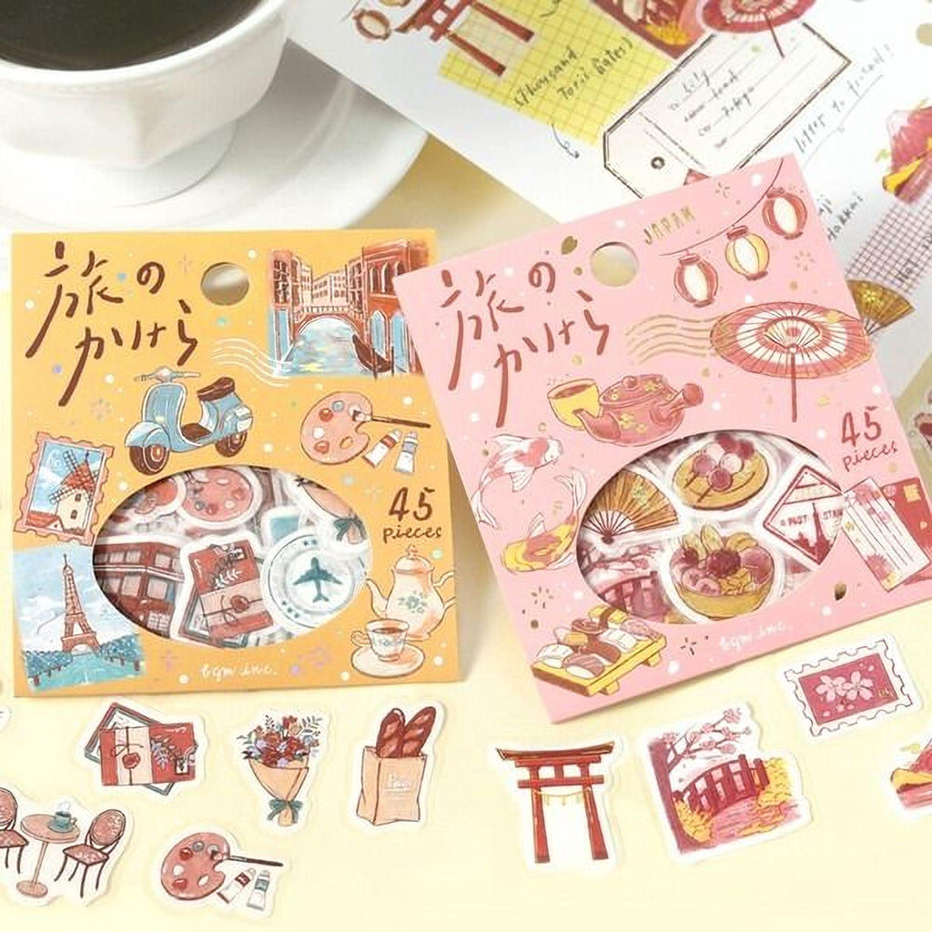 two packages of Japanese-themed stickers, each containing 45 pieces, placed on a table alongside other items such as a cup of coffee and some additional stickers.