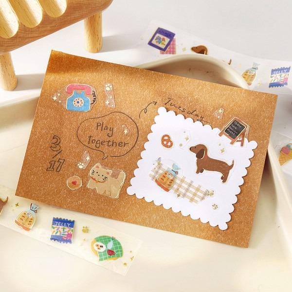 a brown envelope with various stickers and illustrations, including a dog, cat, and other decorative elements.