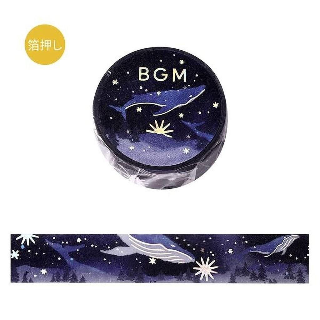 a circular object with a night sky design, including stars, a whale, and a flower. The object is placed above a horizontal band with a similar night sky design.