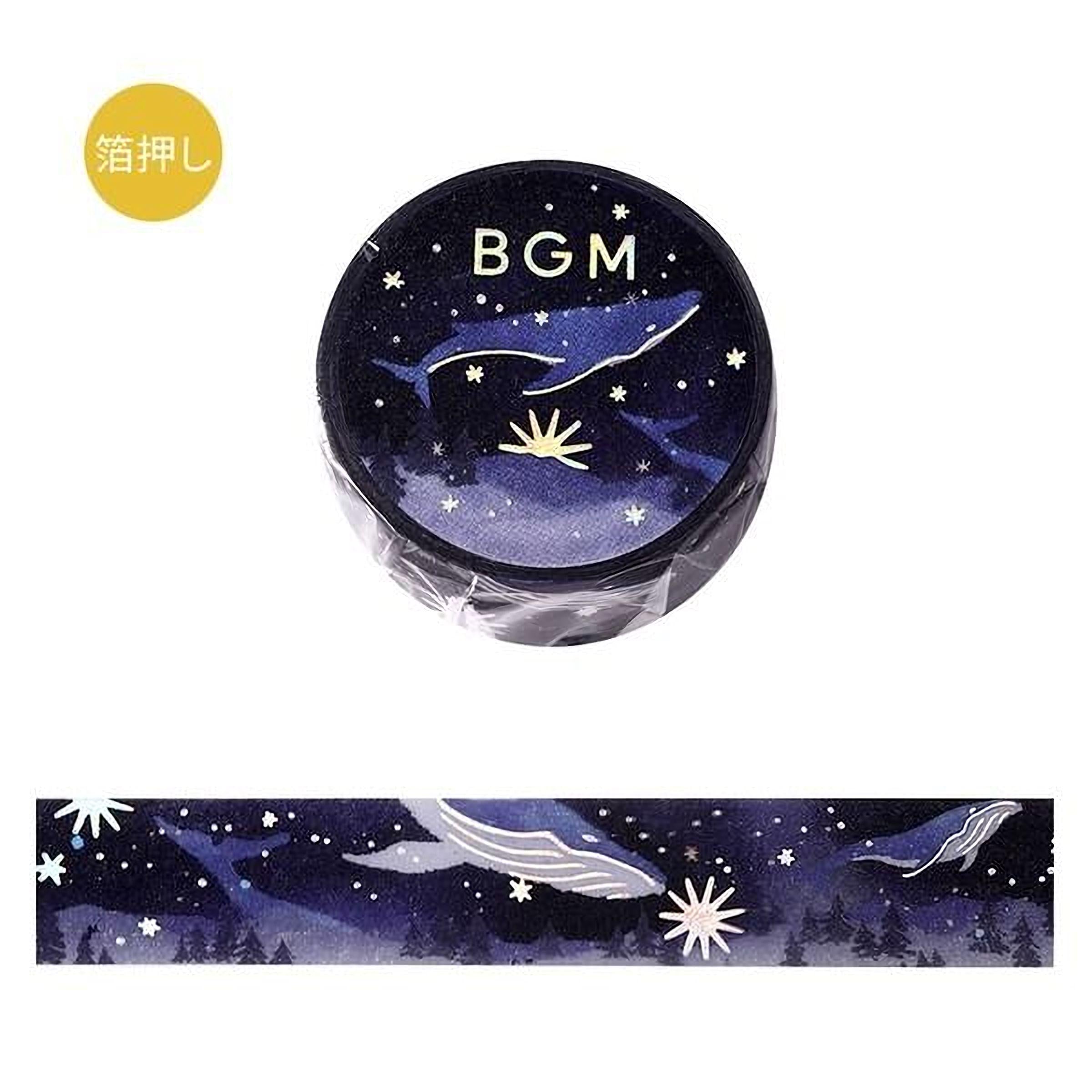 a circular object with a night sky design, including stars, a whale, and a flower. The object is placed above a horizontal band with a similar night sky design.