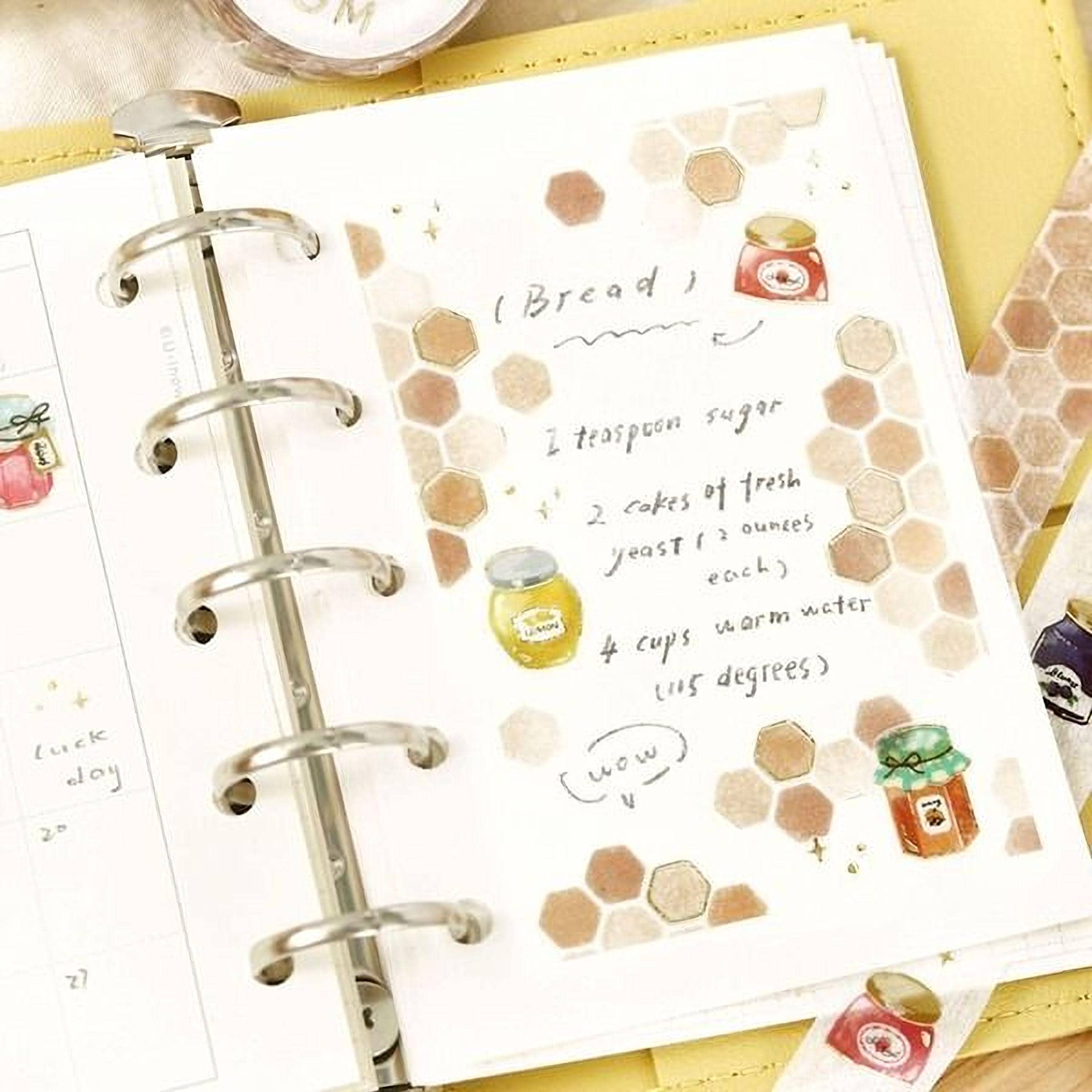 an open spiral-bound notebook with handwritten notes and illustrations, including a recipe for bread and honey.