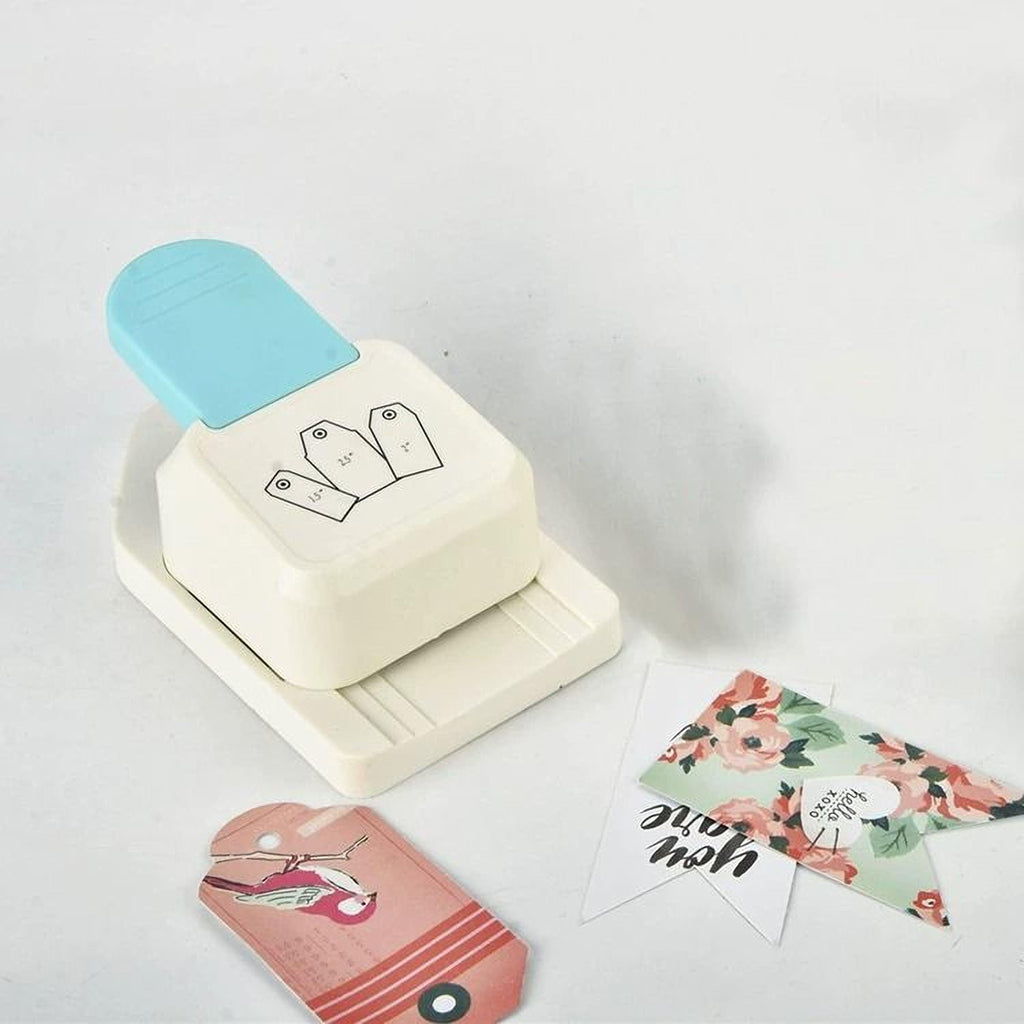 a white hole puncher with a blue handle, surrounded by various craft supplies and decorative items on a white background.