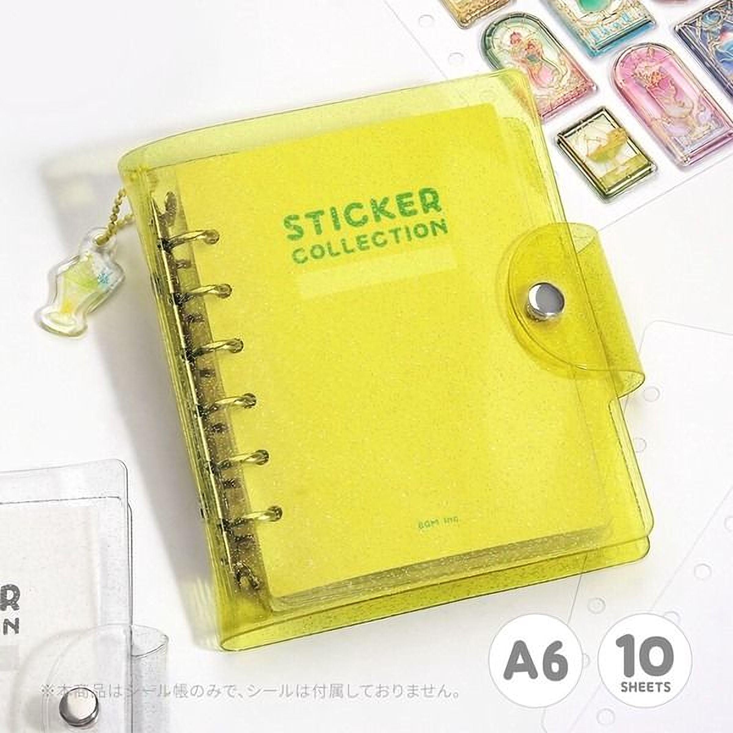 A yellow sticky note pad with the word "STICKER COLLECTION" printed on it, along with a keychain attached to the side.