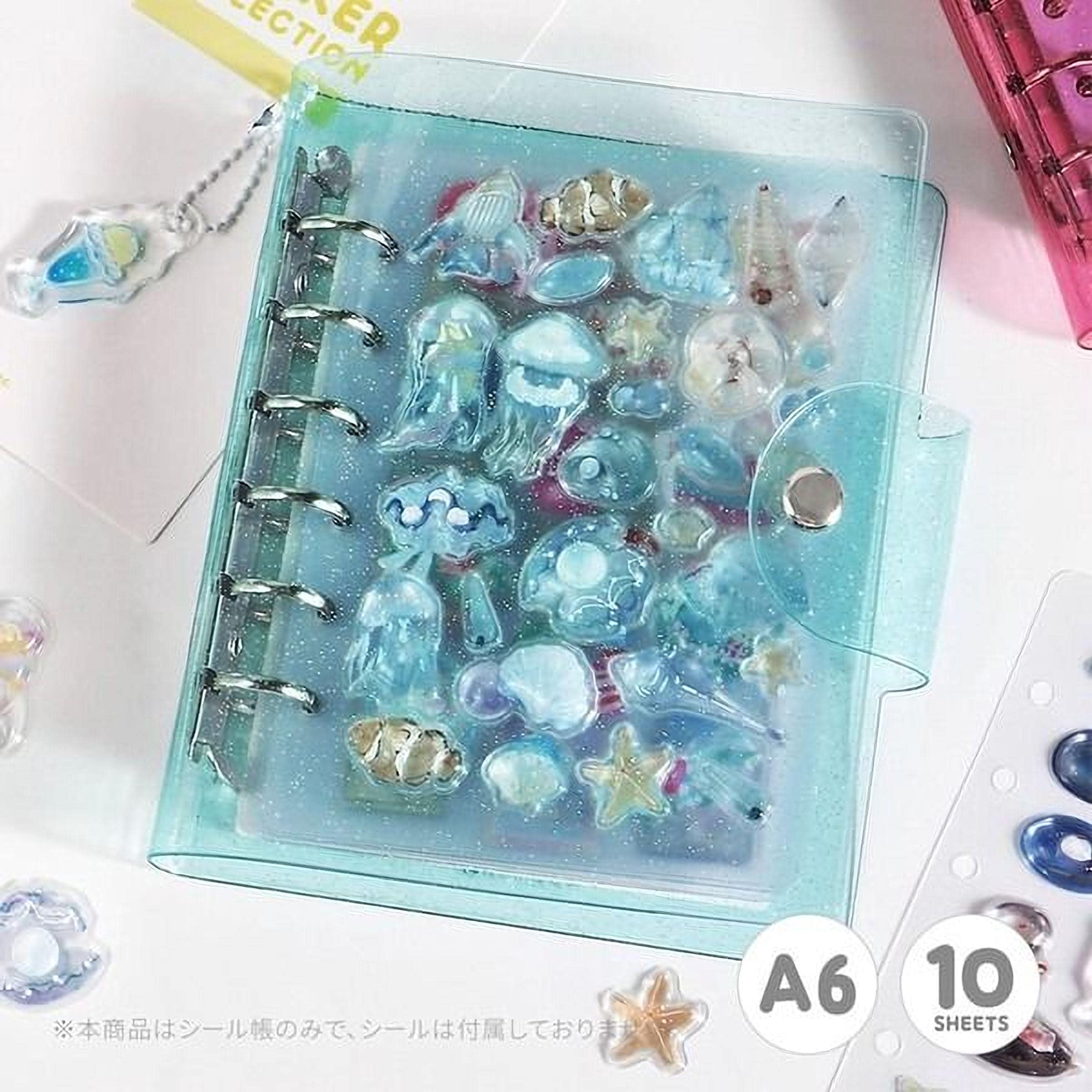 A transparent, glittery, and colorful organizer with various sea-themed items, such as jellyfish, starfish, and seashells, displayed inside it.