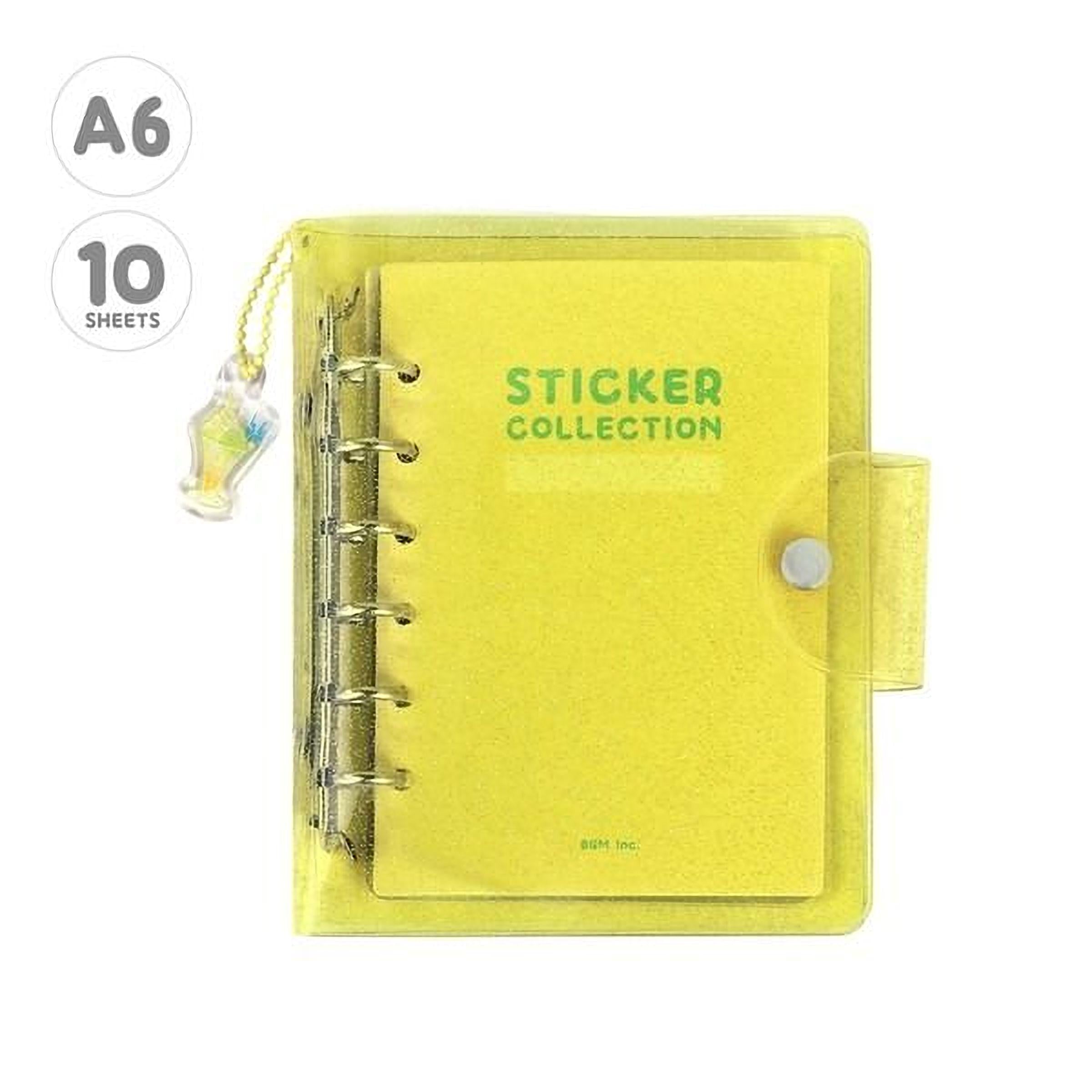 A yellow sticker collection notebook with a clear plastic cover and a small charm attached to the side.