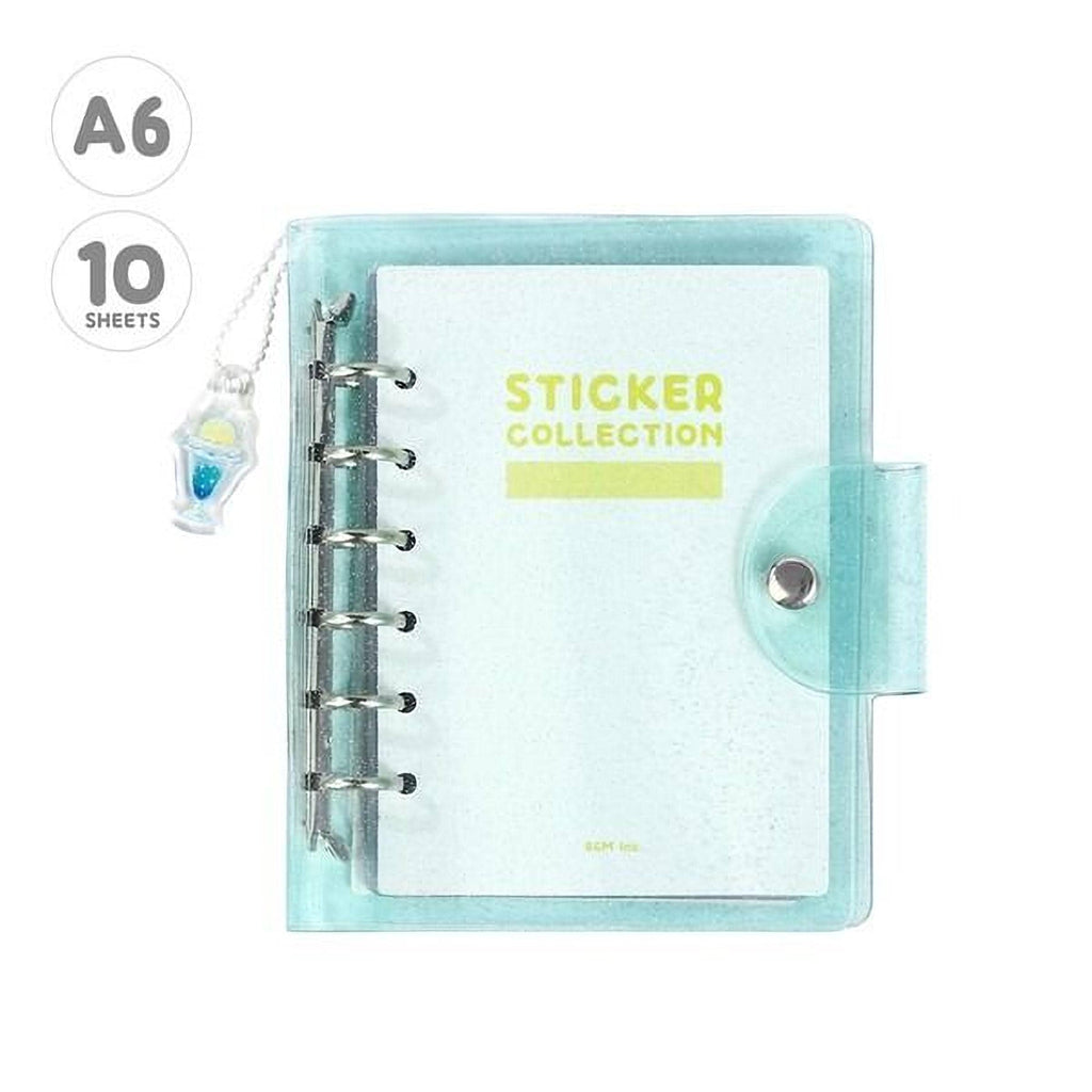 A transparent, mint-colored pocket planner with a spiral binding and a keychain attached to it.