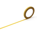 A roll of yellow tape is lying on its side on a white background, with a single yellow line extending from the tape.