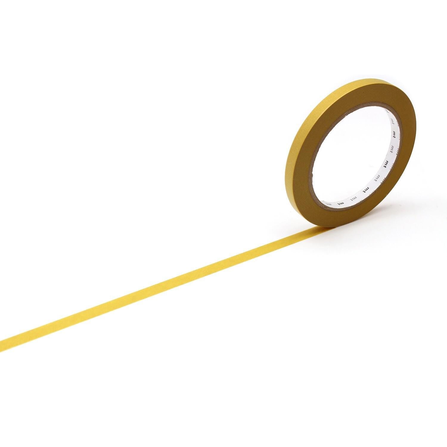 A roll of yellow tape is lying on its side on a white background, with a single yellow line extending from the tape.