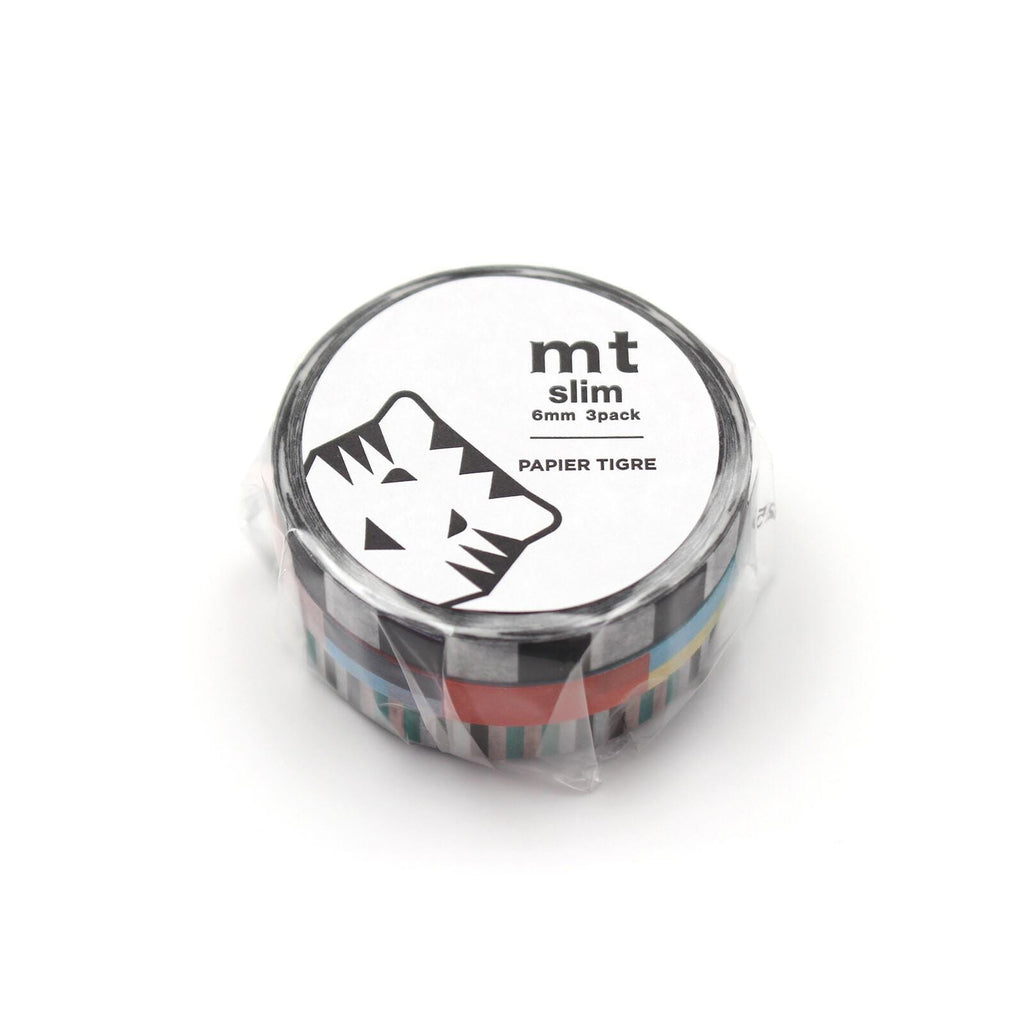 A circular object with a black and white tiger logo on it, and text that reads "mt slim 8mm pack PAPIER TIGRE".