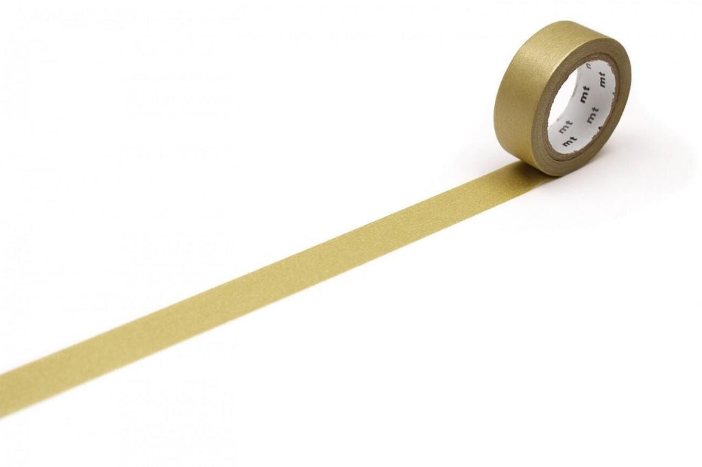 A roll of gold-colored tape is lying on a white surface, with a single gold stripe visible on the tape.