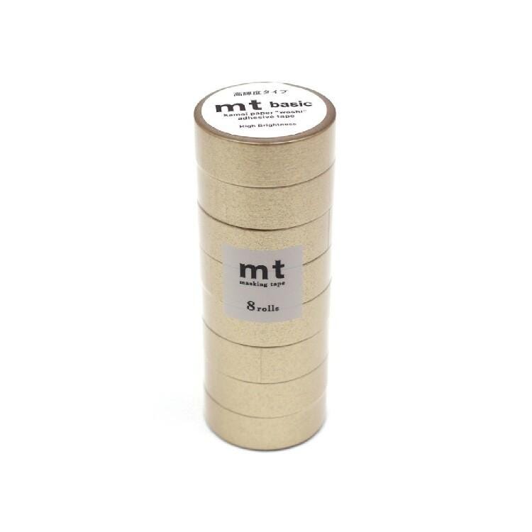 A stack of gold-colored metallic tape rolls with a label that reads "mt basic" and "marking tape".