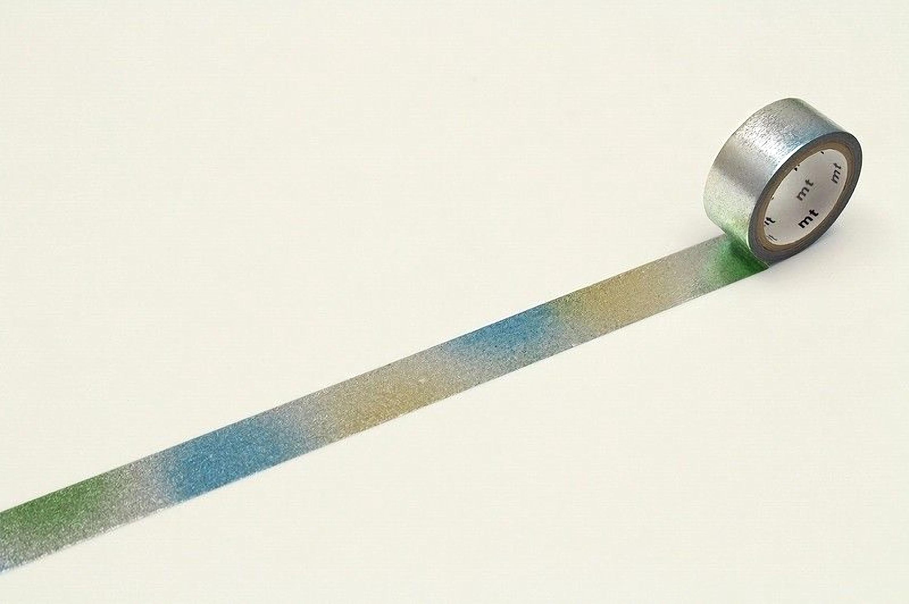 A roll of metallic silver and blue tape is lying on a white surface, with the tape partially unspooled and extending across the image.