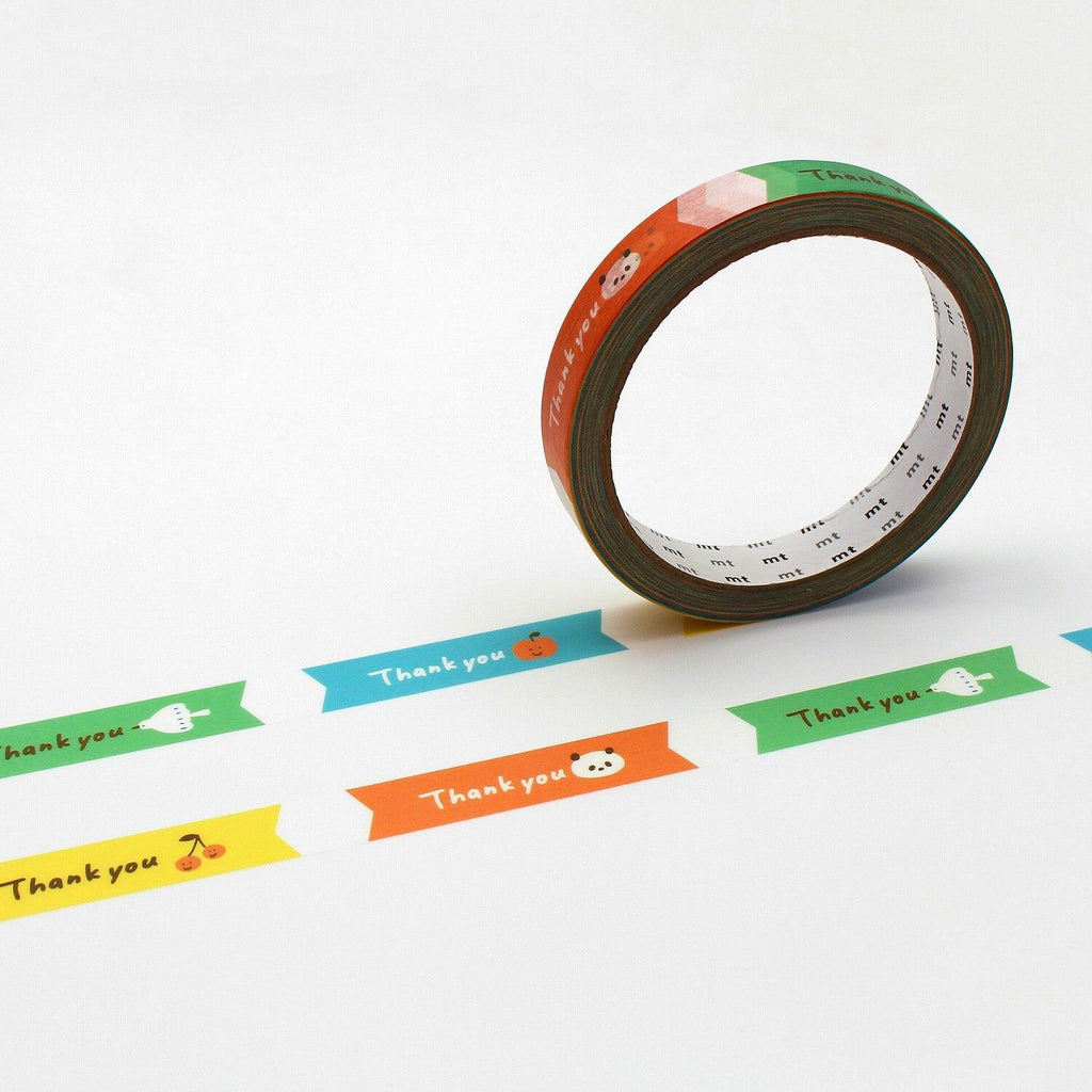 a roll of colorful tape with the words "Thank you" printed on it, along with various cartoon-style illustrations of fruits and vegetables.