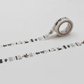 a roll of white tape with black text and graphics printed on it, lying on a white surface.