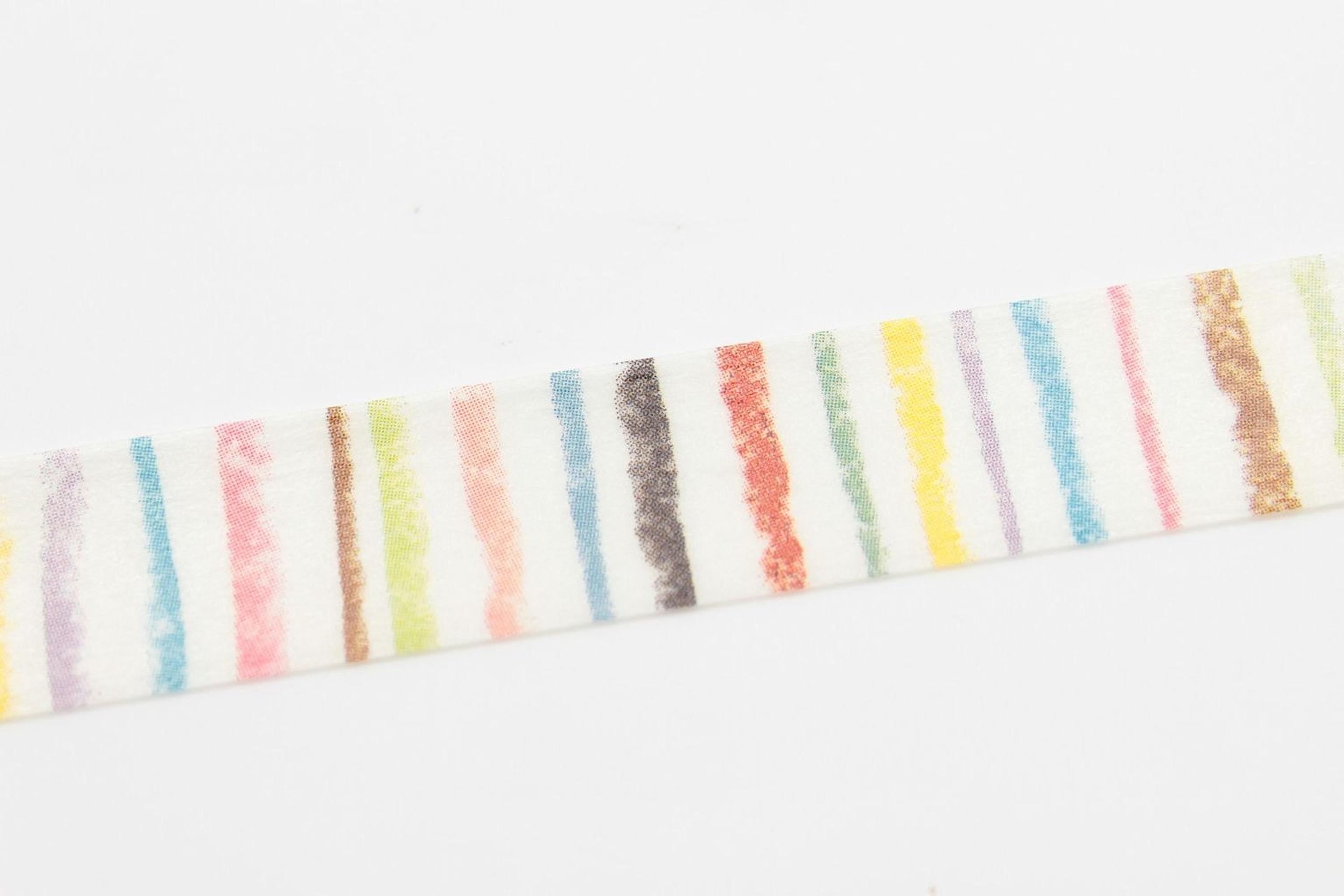 A white object with a striped pattern of various colors, including red, orange, yellow, green, blue, and purple.