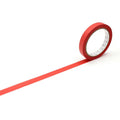 A roll of red tape with a white border is lying on a white surface, with a long red line extending from the tape.