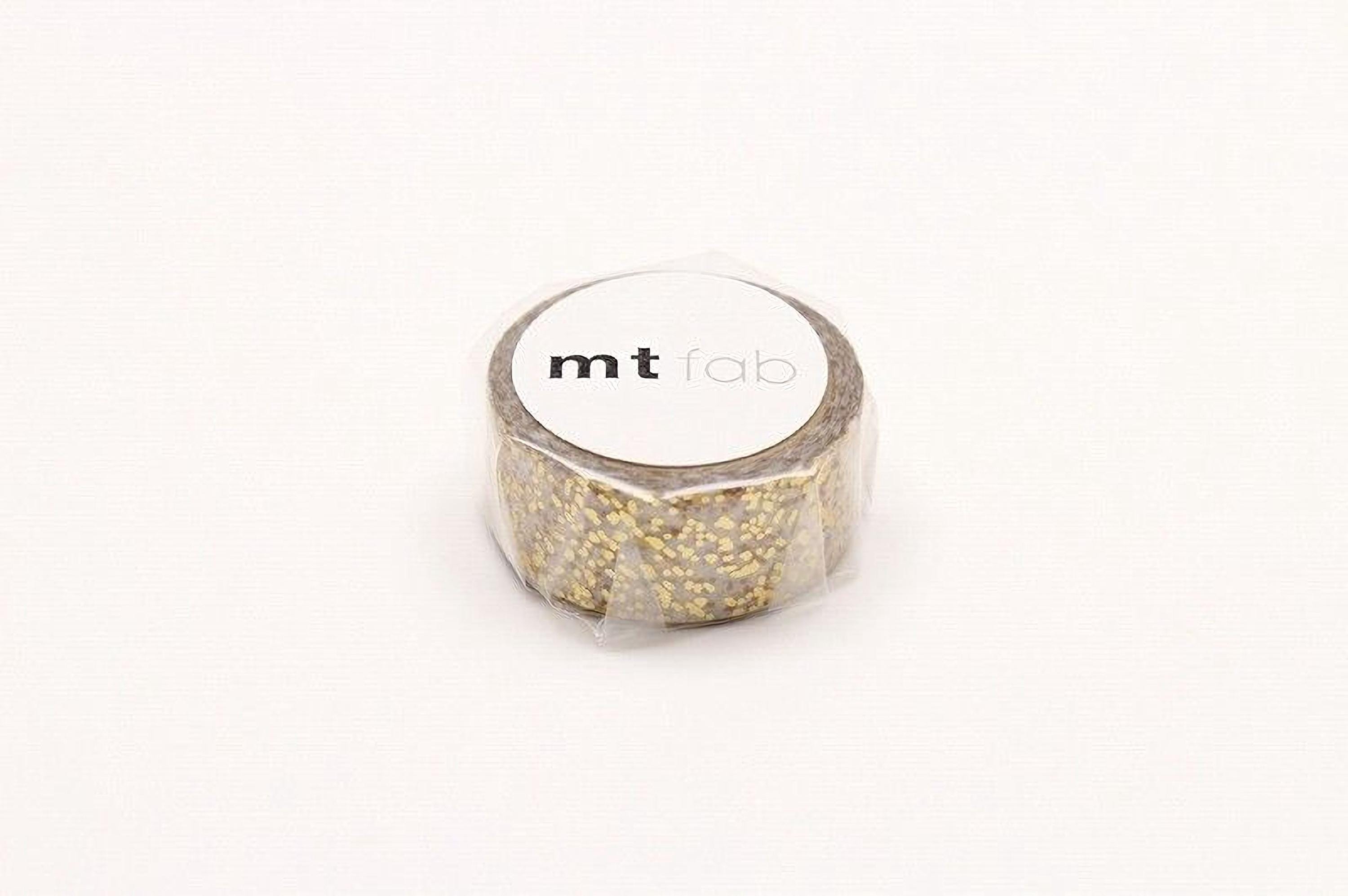 A roll of gold glittery tape with the label "mt lab" printed on it.
