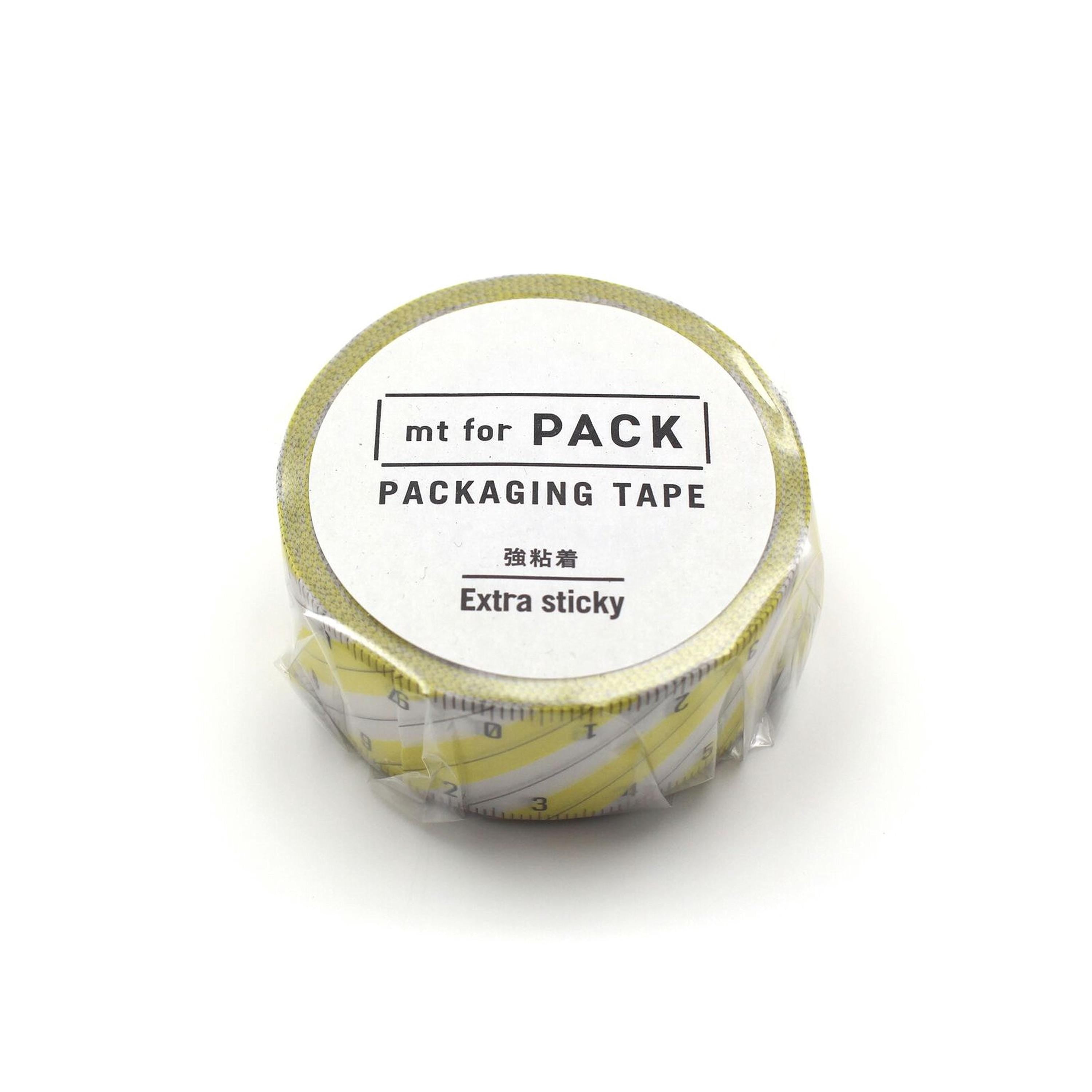 A roll of yellow and white tape labeled "mt for PACK" and "PACKAGING TAPE" with the text "Extra sticky" printed on it.