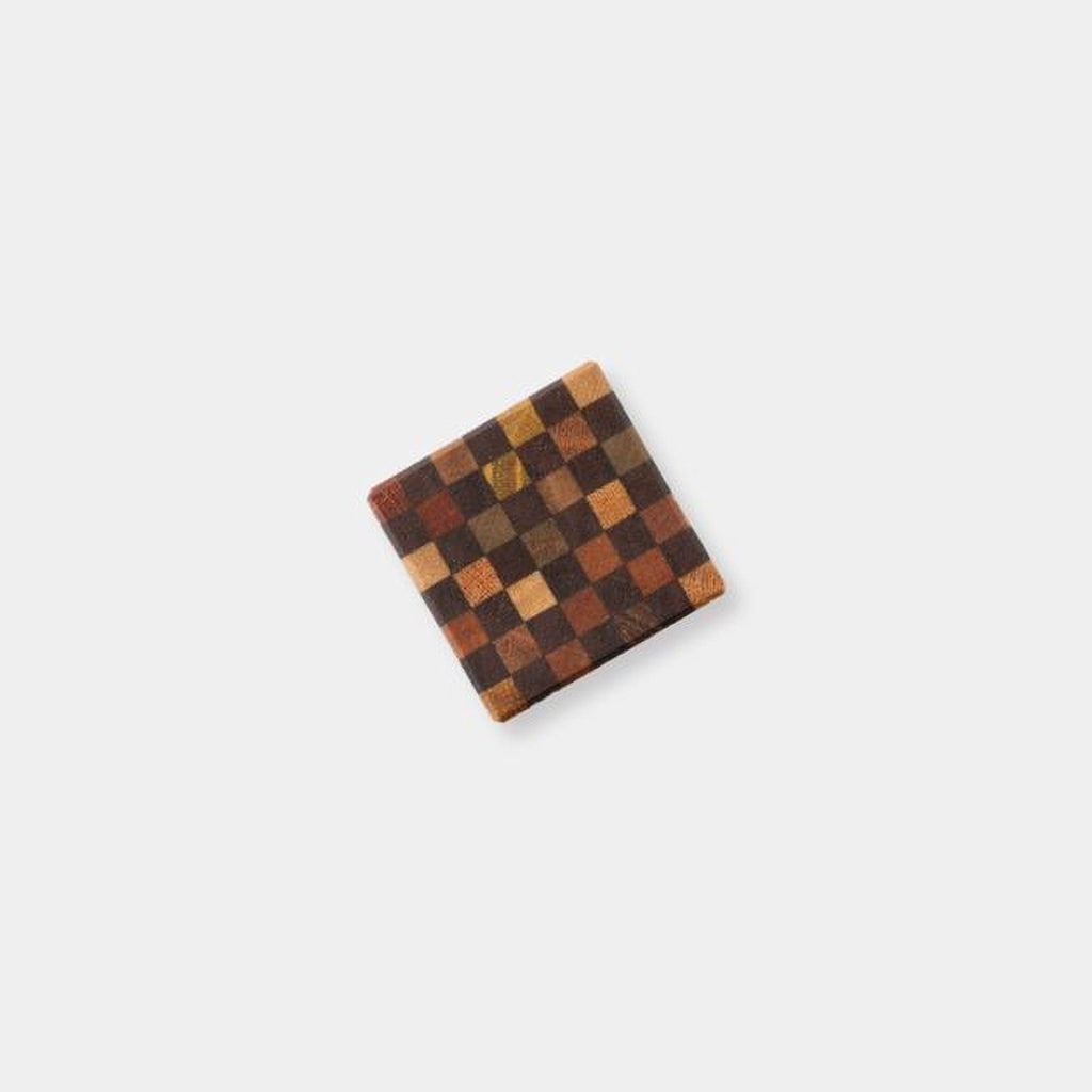 A square-shaped object with a checkered pattern on it, placed against a plain white background.