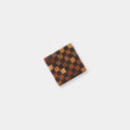 A square-shaped object with a checkered pattern on it, placed against a plain white background.