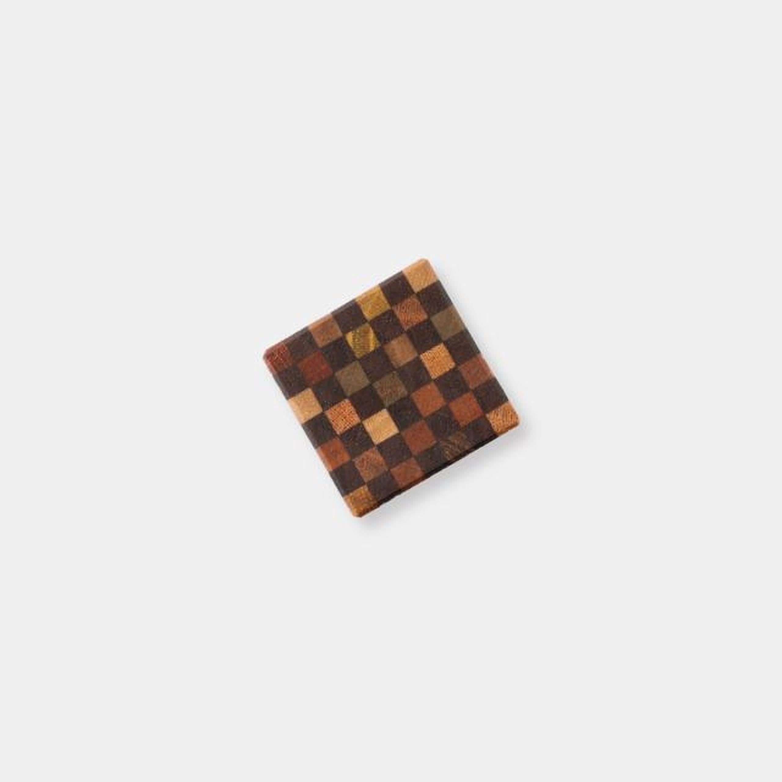 A square-shaped object with a checkered pattern on it, placed against a plain white background.