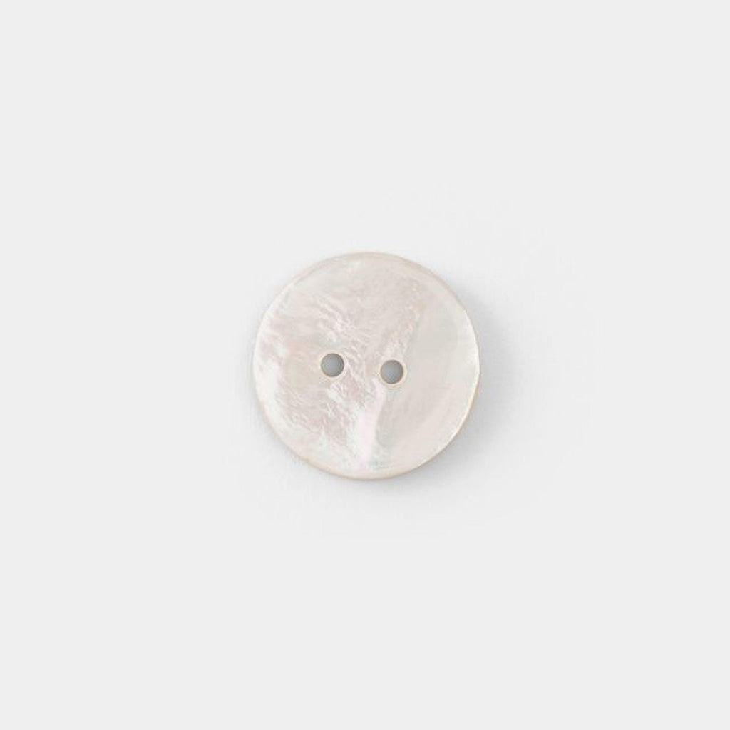 A single white button with two holes is shown against a plain white background.