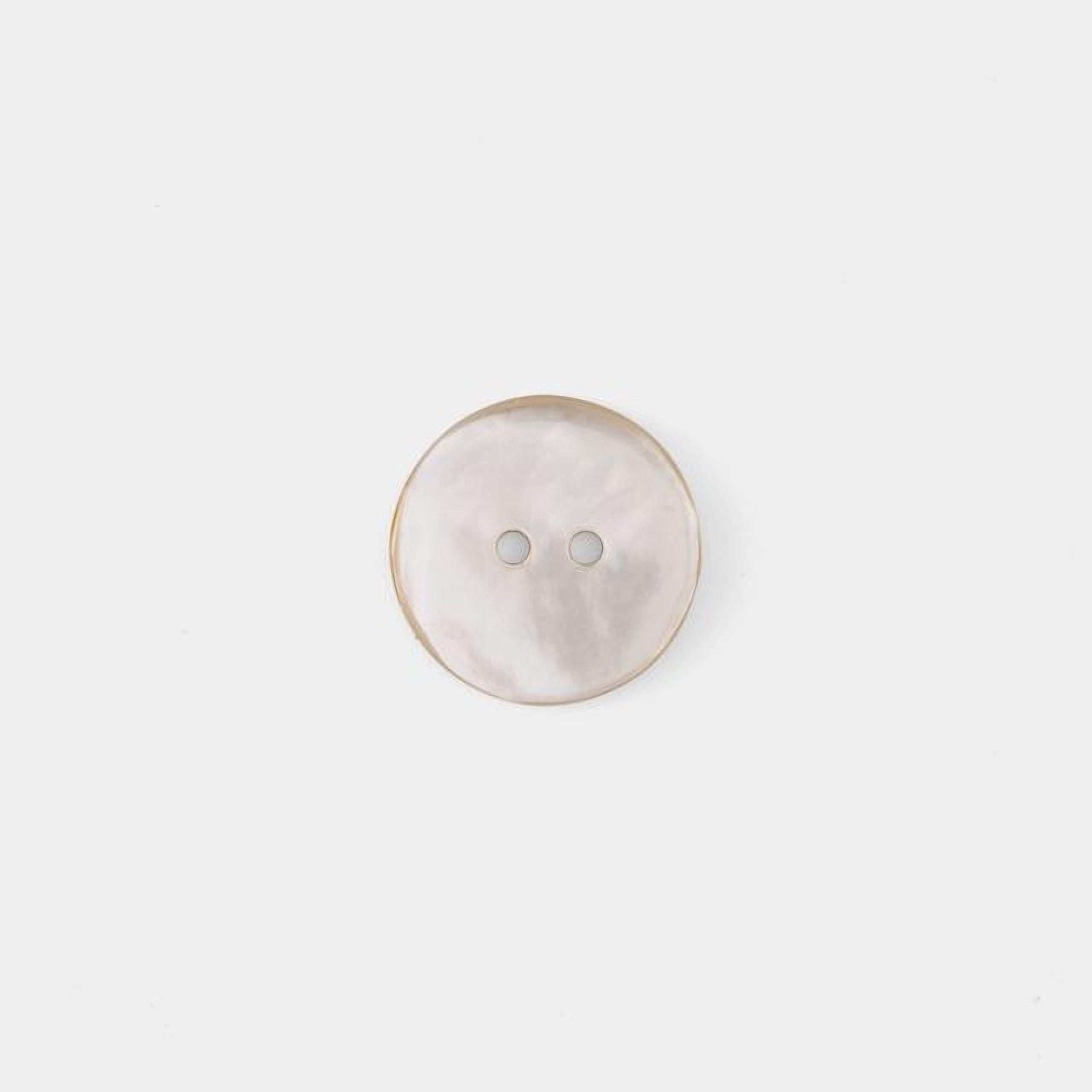 A single, round, white button with two holes is shown against a plain white background.
