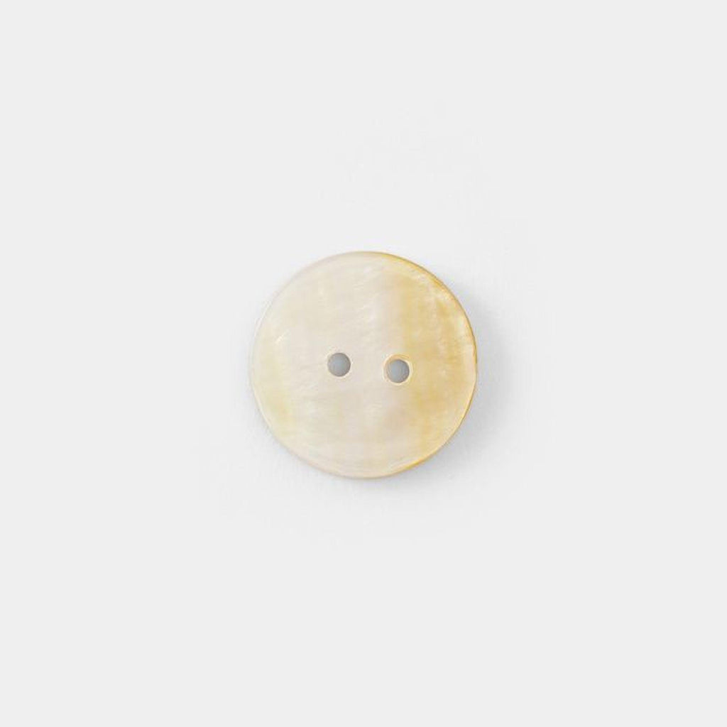 A single, round button with two holes is shown against a plain white background.