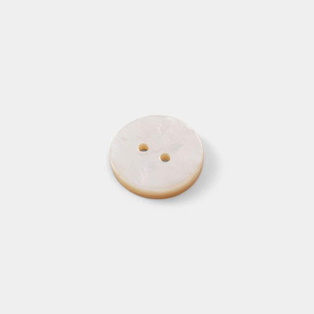 A single white button with two holes is shown against a plain white background.