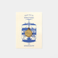 The image is a promotional poster for a train trip by Hokutosei, featuring a blue and white illustration of a train and a gold-colored charm with Japanese characters.