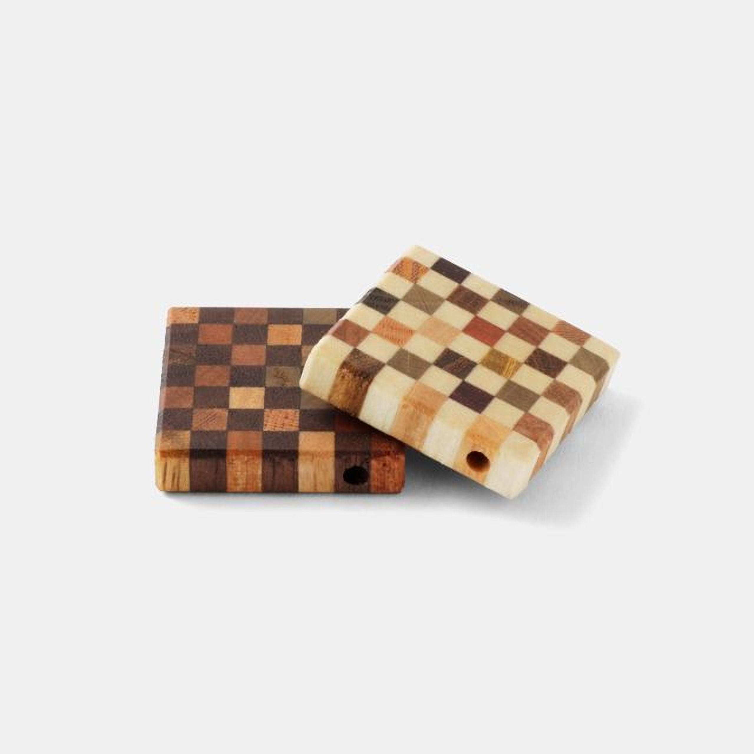 two wooden cutting boards with a checkered pattern, one with a darker color and the other with a lighter color.
