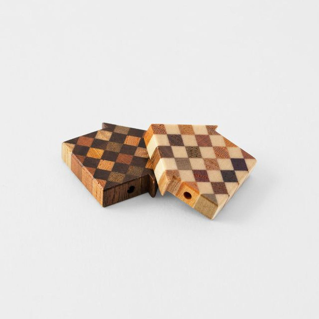 Two wooden blocks with a checkered pattern are placed on a white background.