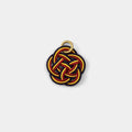 A colorful, braided piece of string or thread with a gold ring attached to it.