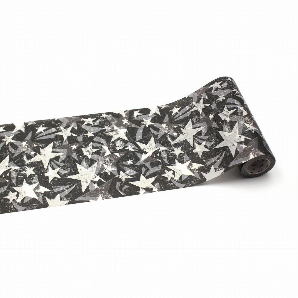 A roll of black and white star-patterned tape is shown against a white background.