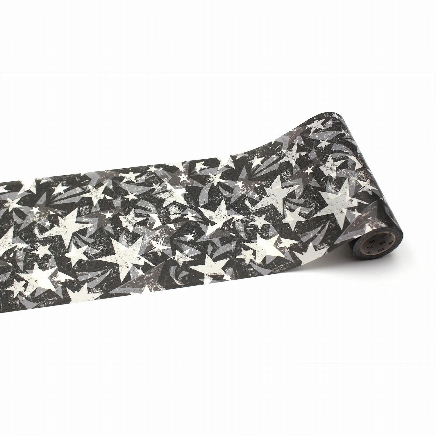 A roll of black and white star-patterned tape is shown against a white background.