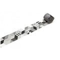 A roll of black and white geometric pattern tape is lying on a white surface.