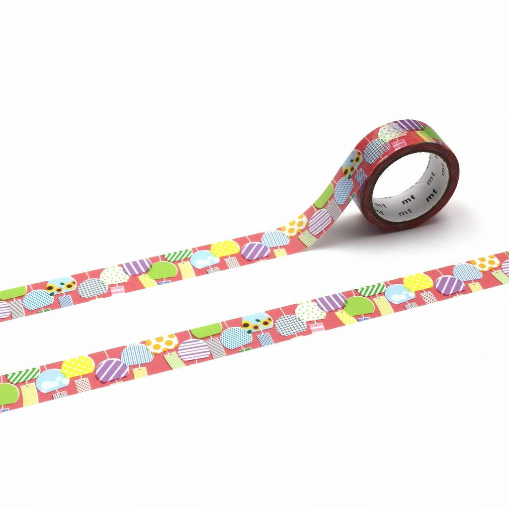 a roll of colorful patterned tape with a repeating design of various shapes and colors, including circles, triangles, and squares.