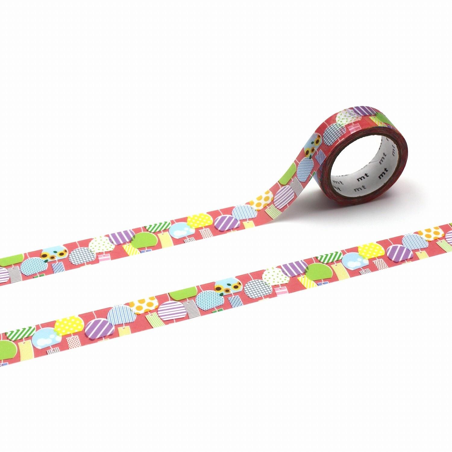 a roll of colorful patterned tape with a repeating design of various shapes and colors, including circles, triangles, and squares.