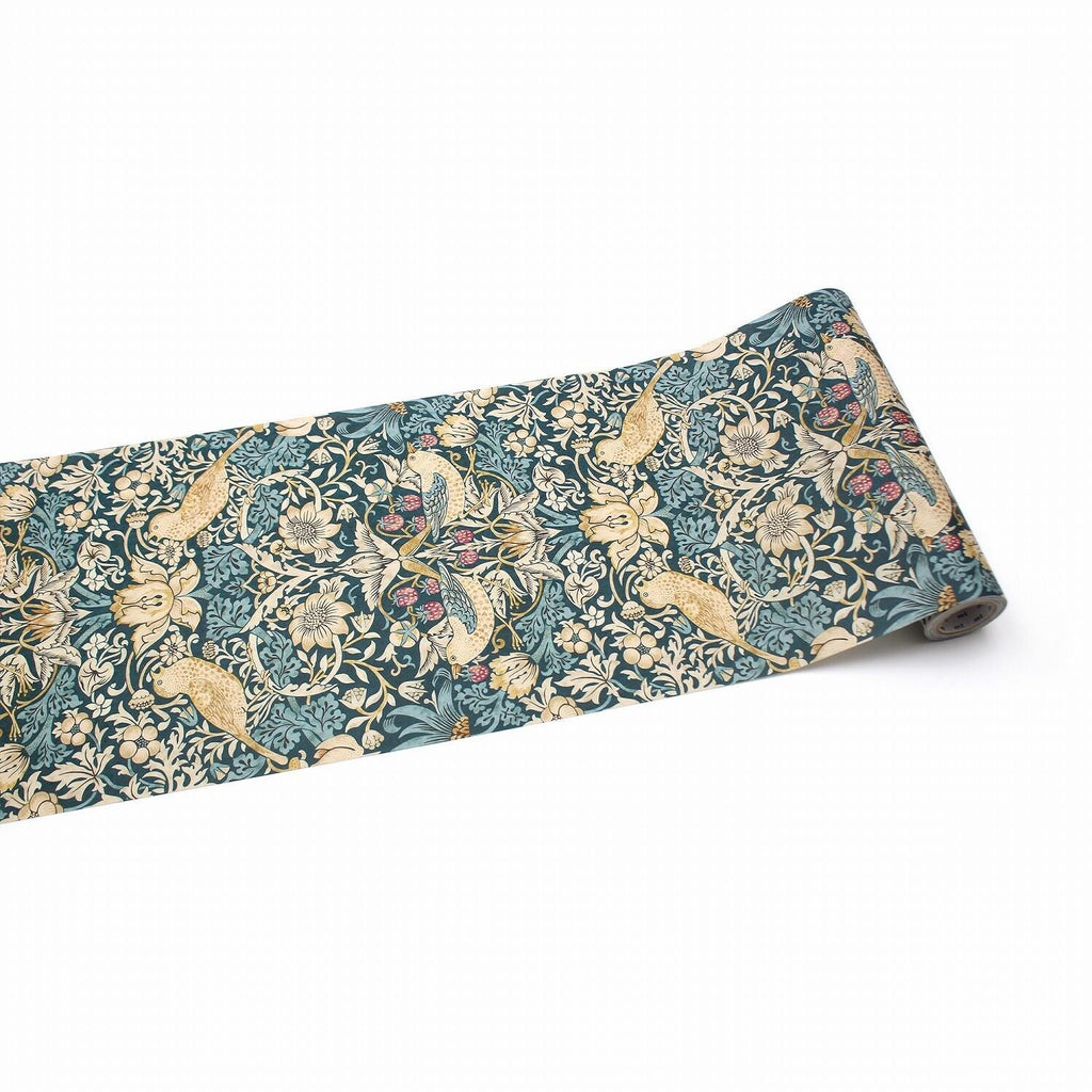 a roll of wallpaper with a floral pattern in shades of blue and green.