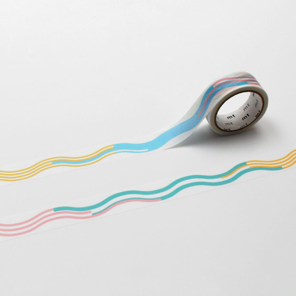 A roll of colorful tape with a wavy pattern is lying on a white surface.