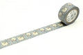A roll of patterned tape with a floral design is placed on a white surface.