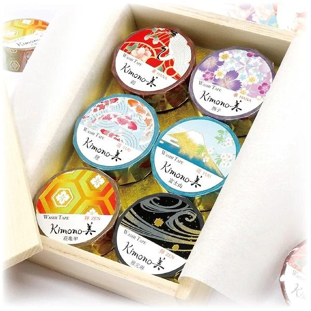 A wooden box containing six round, colorful washi tape rolls with Japanese designs.