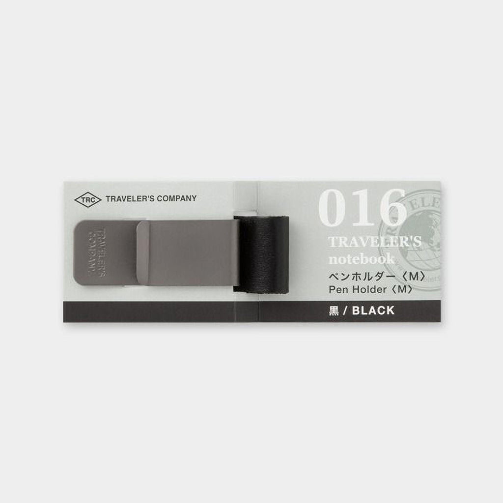 A black and grey travel notebook with a black pen holder attached to it.