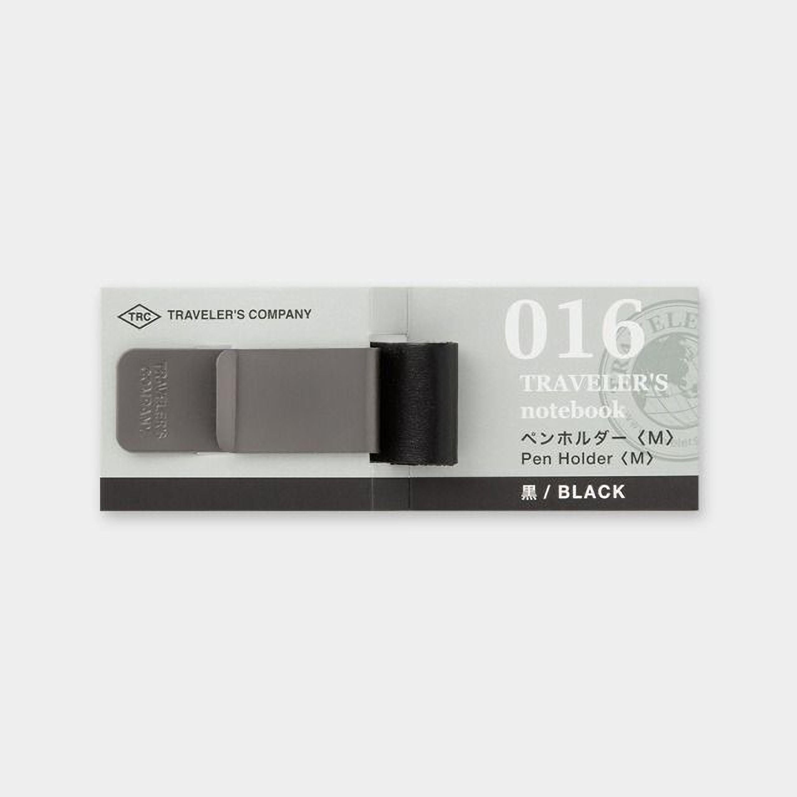 A black and grey travel notebook with a black pen holder attached to it.