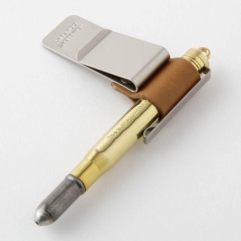 A bullet-shaped pen with a metal clip attached to it.