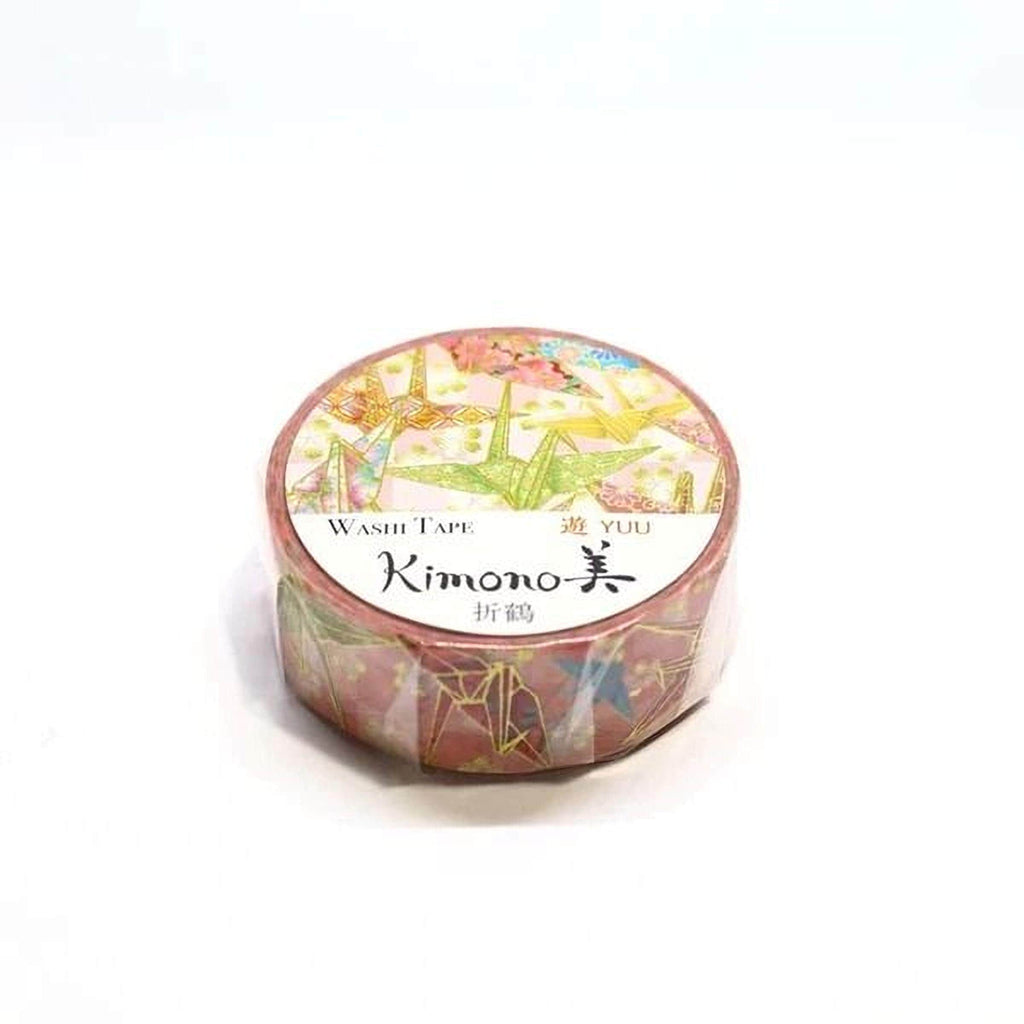 A round, pink and green washi tape roll with a colorful, abstract pattern.