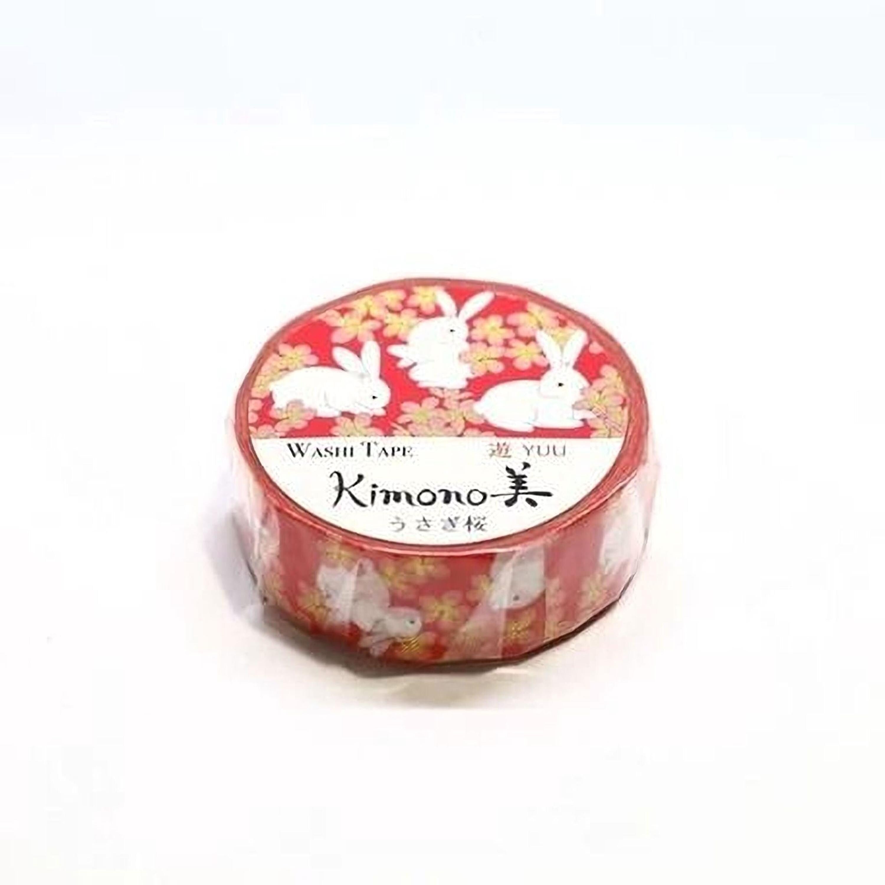 A red and white roll of washable paper tape with a pattern of white rabbits on a red background.