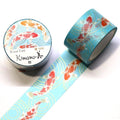 a roll of blue washi tape with a pattern of koi fish on it, and a round container of the same type of tape.