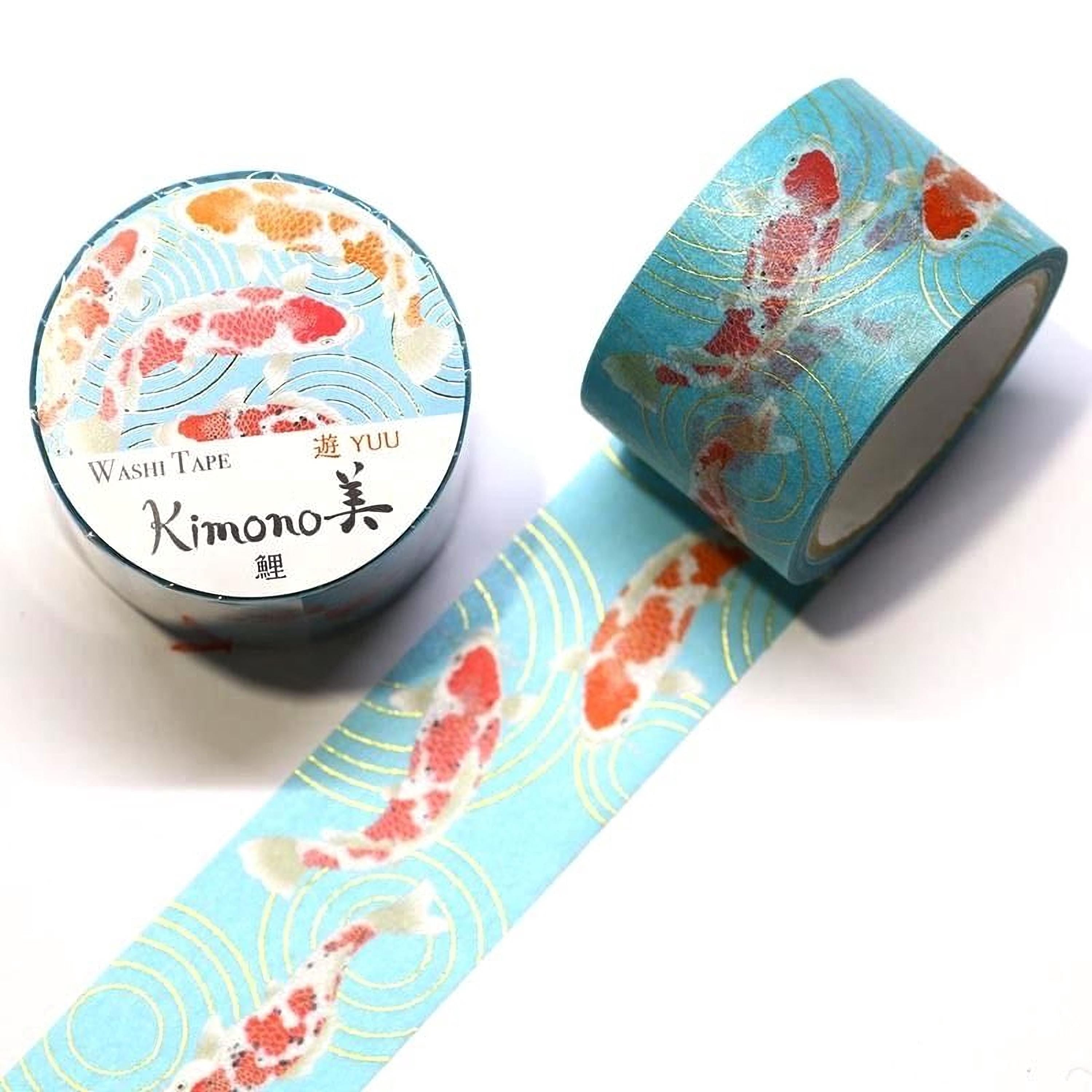 a roll of blue washi tape with a pattern of koi fish on it, and a round container of the same type of tape.